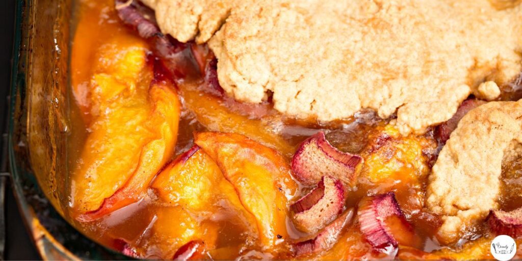 Close-up of peach cobbler showing juicy peaches and golden cake layer