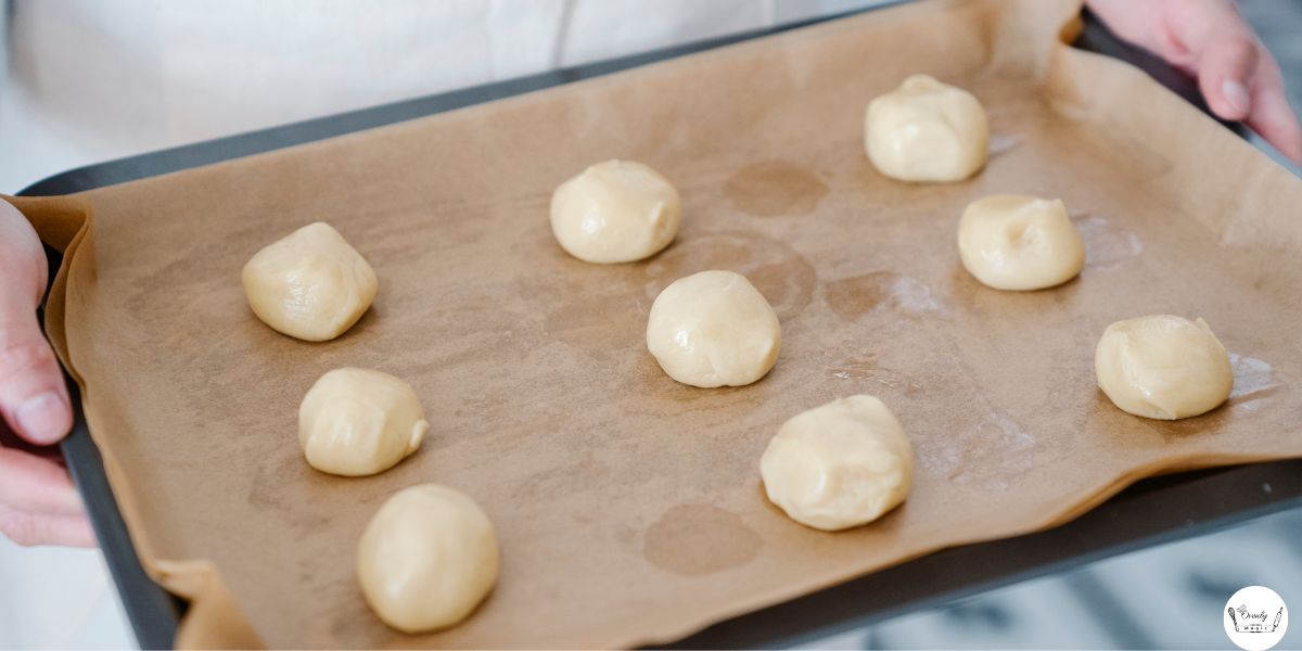 Unbaked 3 ingredient sugar cookies dough shaped into balls on baking tray