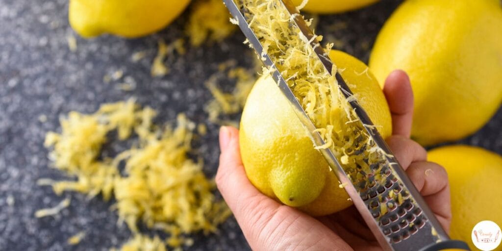 Grating fresh lemon for lemon blueberry bread recipe to collect lemon zest
