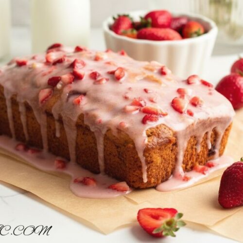 Sliced strawberry bread with pink glaze served on a plate, fresh strawberries on the side, soft and juicy”