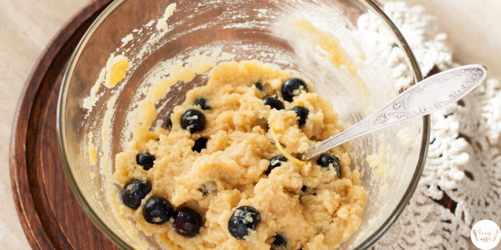 Lemon blueberry bread batter being mixed in a bowl