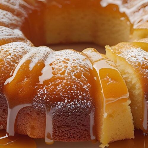 A moist pineapple juice cake with glaze dripping down the sides, served on a white plate.