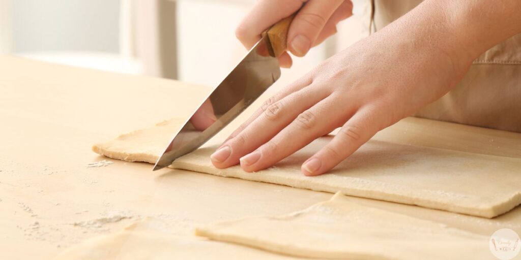 Alt text: Cut puff pastry squares for guava and cheese pastries recipe