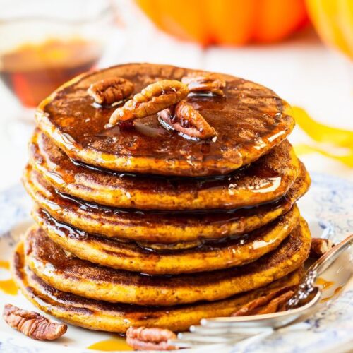 Fluffy Perkins pumpkin pancakes stacked with maple syrup and butter – perfect fall breakfast.
