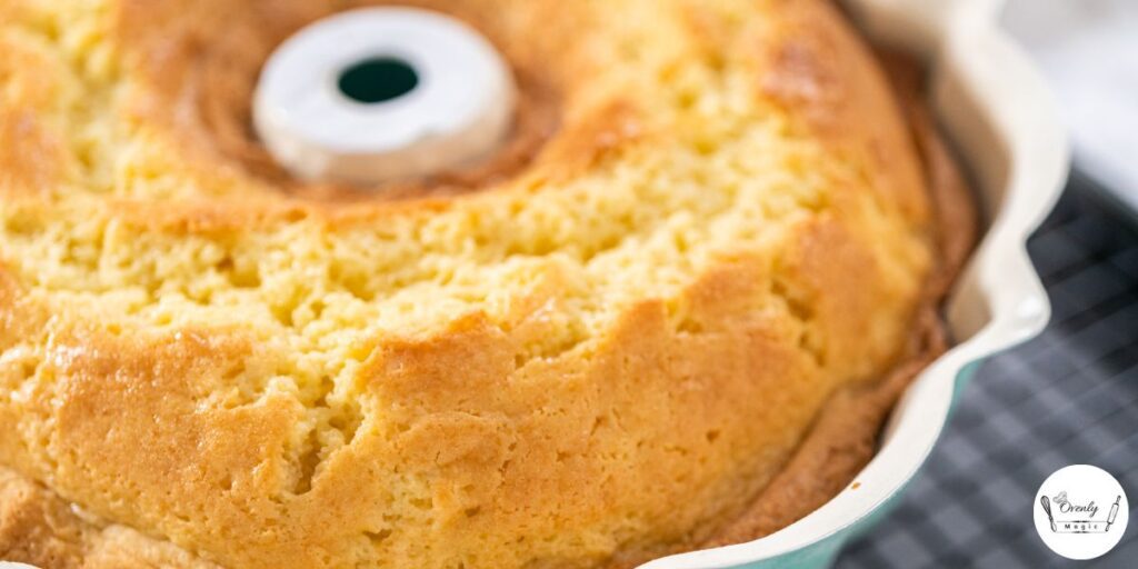 Freshly baked pineapple juice cake resting in the pan on a wire rack.