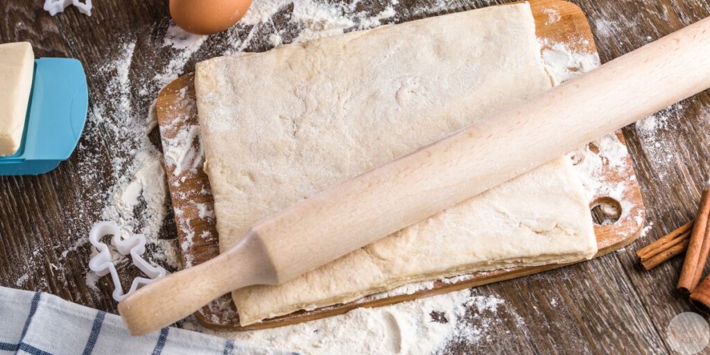 Rolling puff pastry sheet for homemade guava and cheese pastries