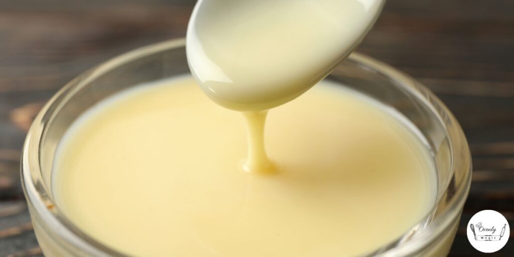 Simple vanilla glaze being mixed in a bowl using powdered sugar, milk, and vanilla—perfect for topping the strawberry honey bun cake.