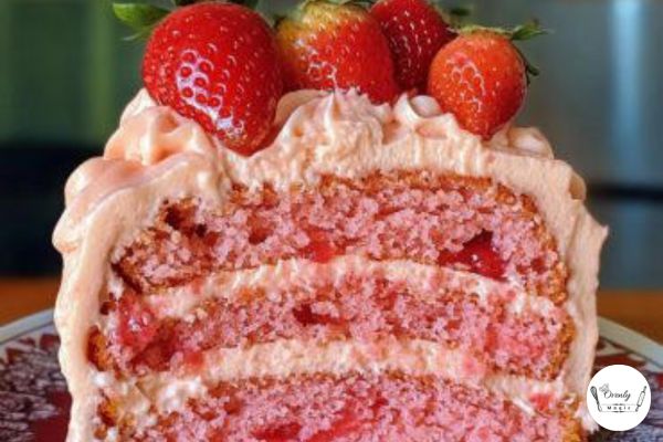 Drizzling glaze on top of the freshly baked strawberry honey bun cake.
