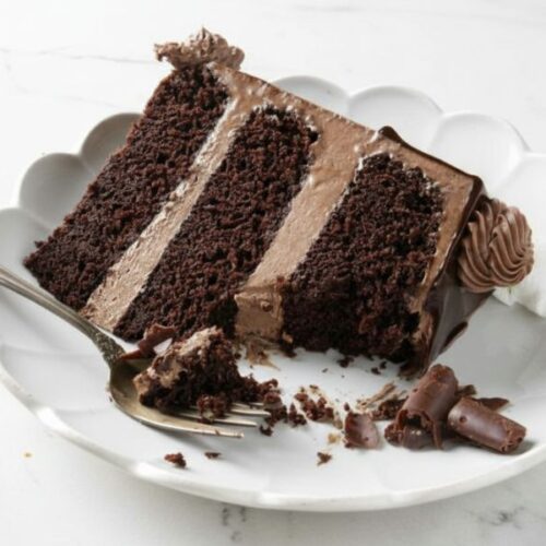 Delicious triple layer chocolate cake with rich chocolate frosting and chocolate drizzle