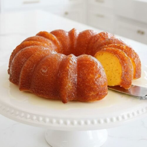 Moist and soft pineapple juice cake with glaze on top, served on a white plate