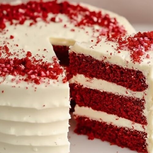 Red velvet cake fully frosted with smooth cream cheese frosting