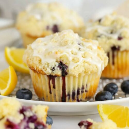 Freshly baked lemon blueberry muffins with golden domes and juicy blueberries