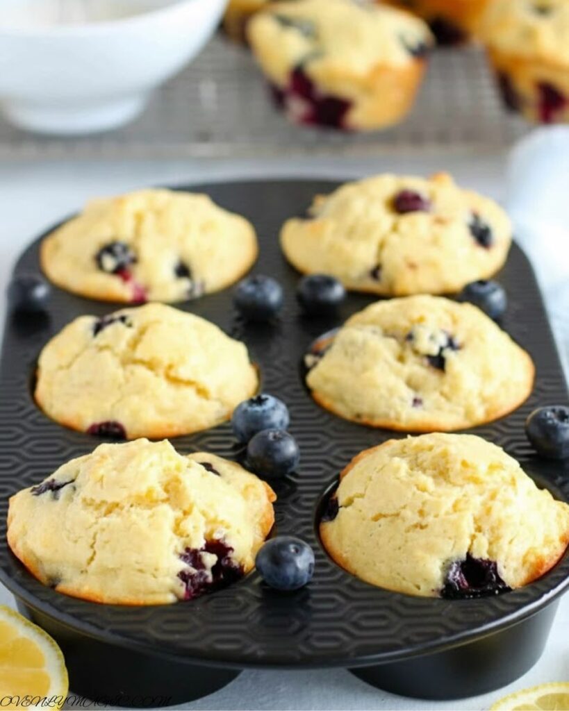 Freshly baked lemon blueberry muffins with golden domes and juicy blueberries, bakery-style at home
