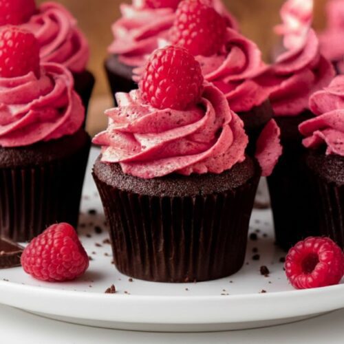 Homemade chocolate raspberry cupcakes arranged on a platter, perfect for parties or dessert tables.”