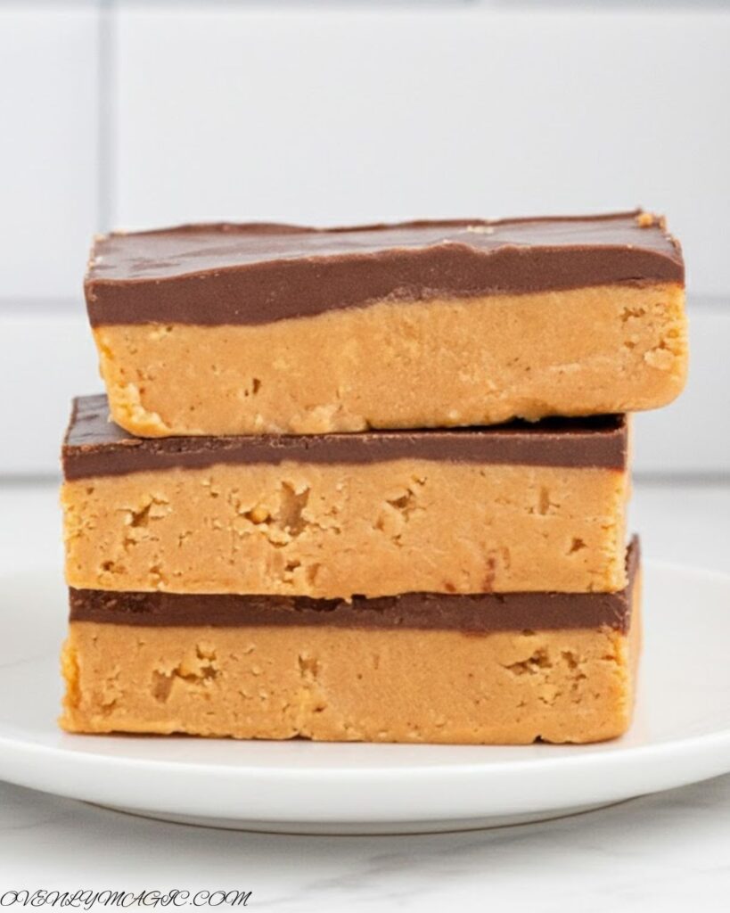 No-Bake Peanut Butter Bars cut into squares with smooth chocolate top and creamy peanut butter base
