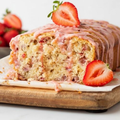 Slice of moist strawberry banana bread showing soft crumb and strawberry pieces