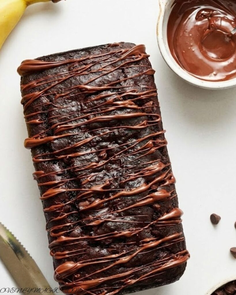 Sliced Double Chocolate Banana Bread with gooey chocolate chips, moist banana texture, and rich chocolate swirls, served on a rustic plate.