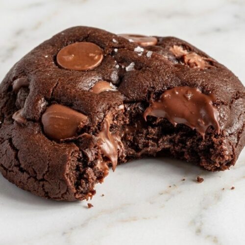 Double chocolate chip cookies stacked on a plate, ready to serve