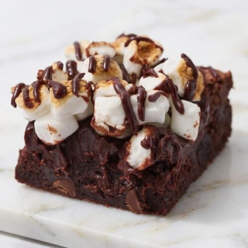 Chocolate brownies topped with ganache and toasted marshmallows