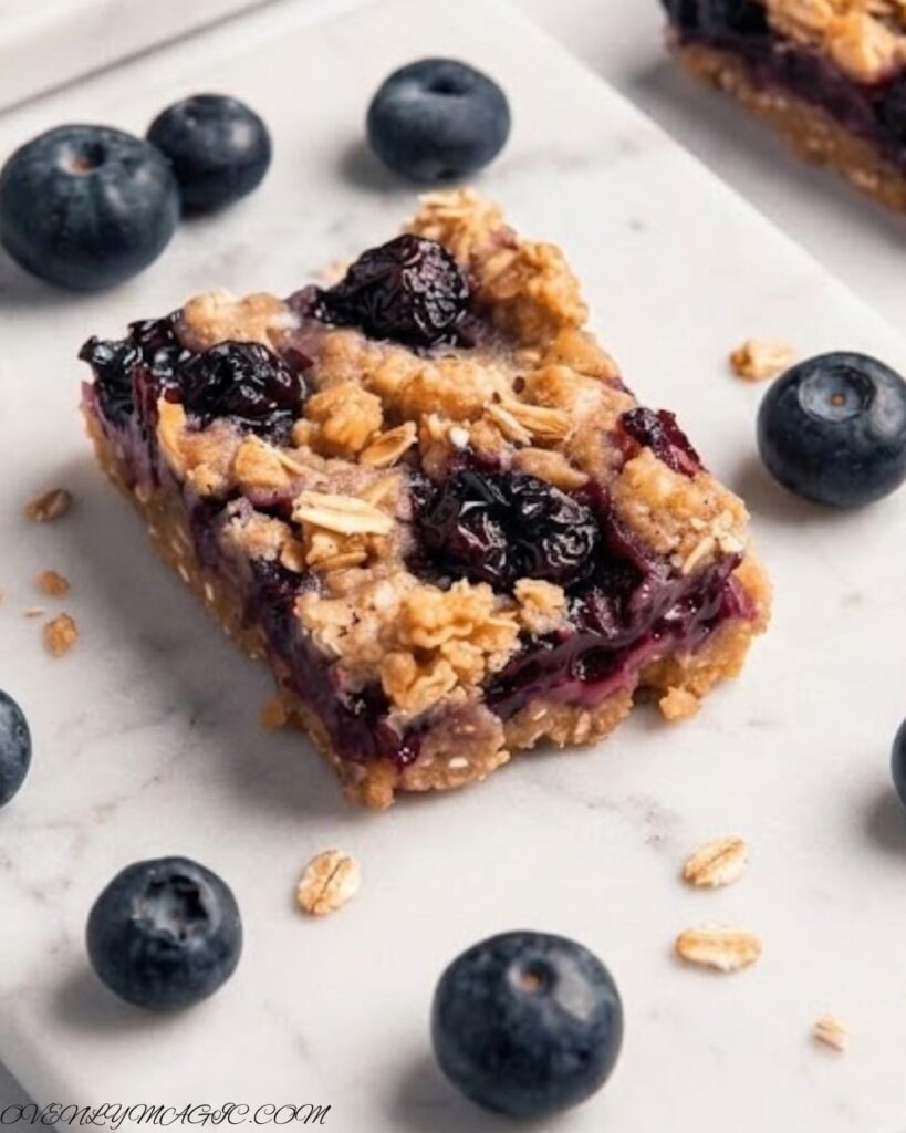 Freshly baked blueberry oatmeal bars with golden edges